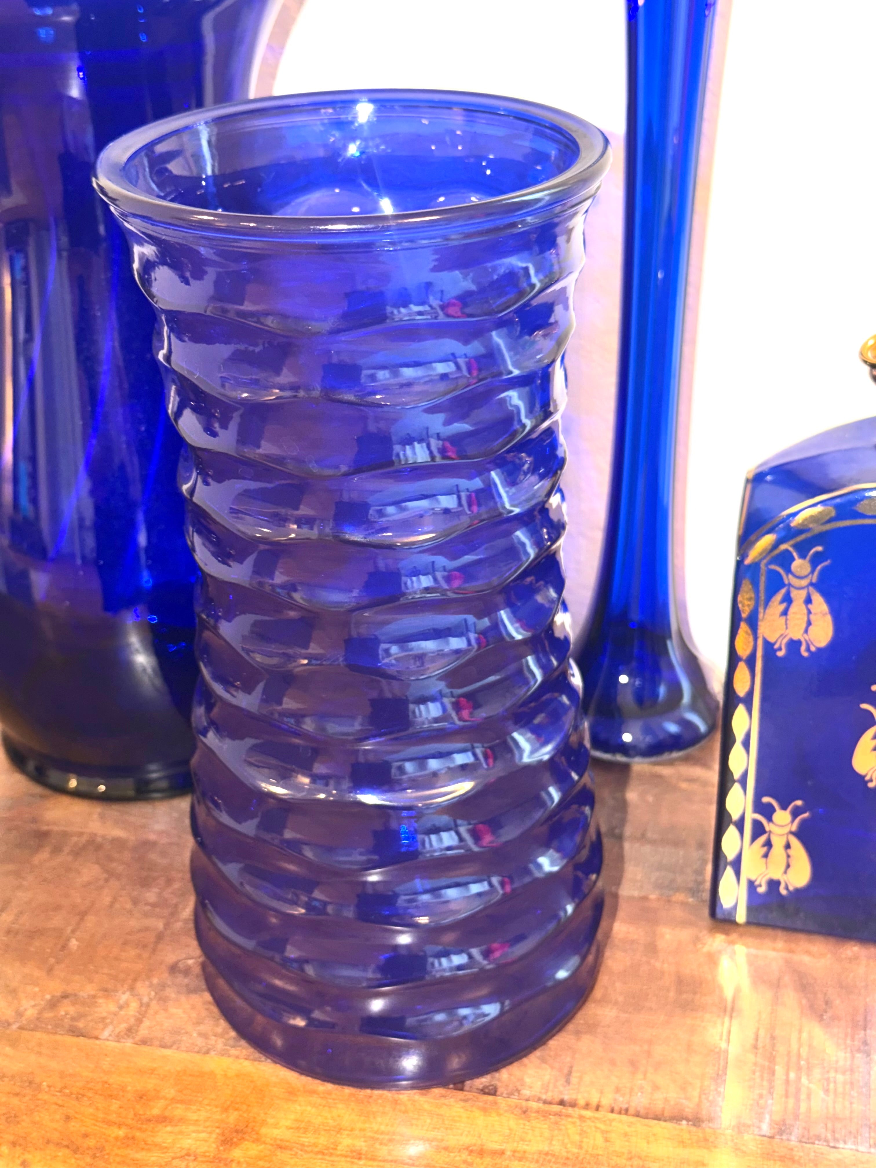 Cobalt blue art glass vase featuring a sculptural ribbed design and rich sapphire color. An elegant Mid-Century decorative accent for refined interiors.