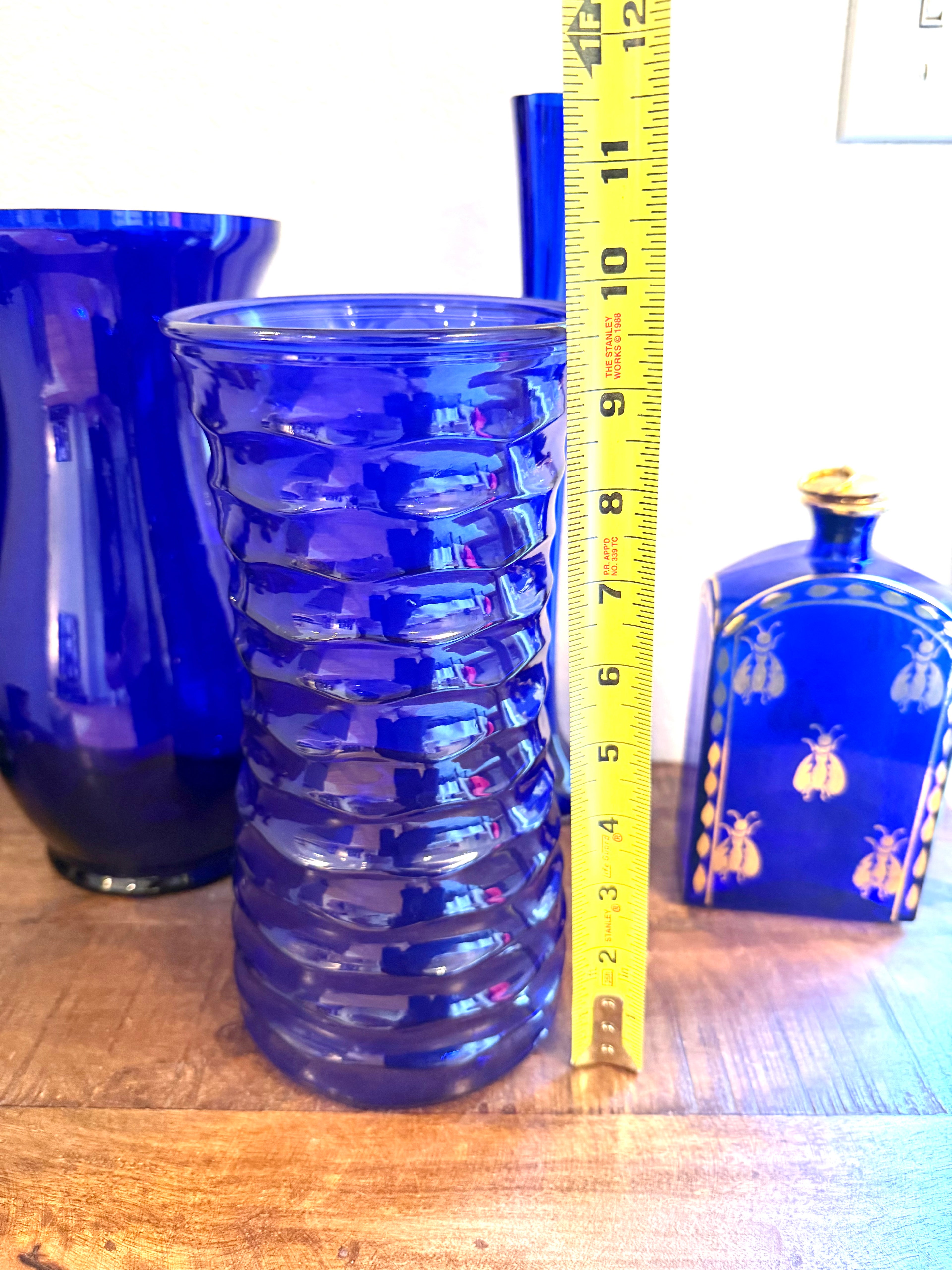 Cobalt blue art glass vase featuring a sculptural ribbed design and rich sapphire color. An elegant Mid-Century decorative accent for refined interiors.