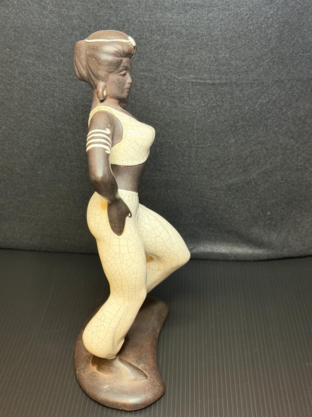A beautifully sculpted mid-century ceramic figure capturing grace, strength, and quiet poise.