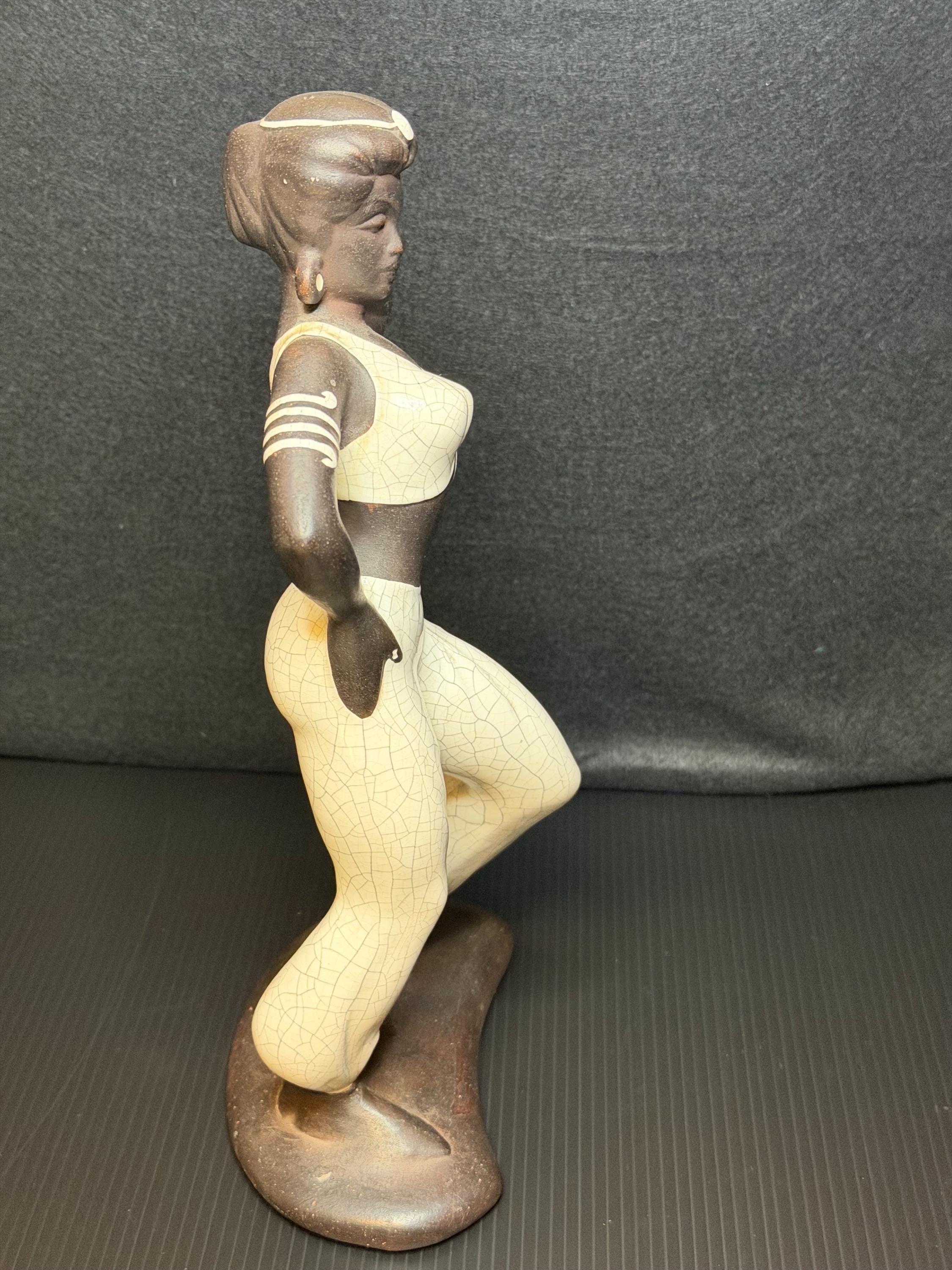 A beautifully sculpted mid-century ceramic figure capturing grace, strength, and quiet poise.